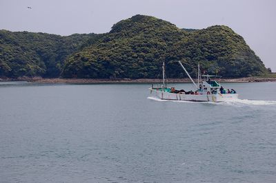 宇久井港から出港する漁船